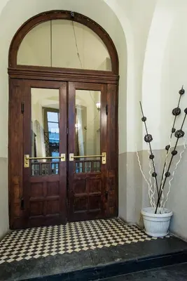 an entrance to a building with a wooden door at Apartamenty Gołębia 3 in Kraków