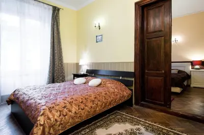 a bedroom with a bed with two pillows on it at Apartamenty Gołębia 3 in Kraków
