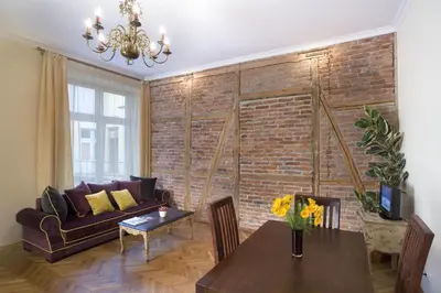 a living room with a couch and a table at Apartamenty Gołębia 3 in Kraków