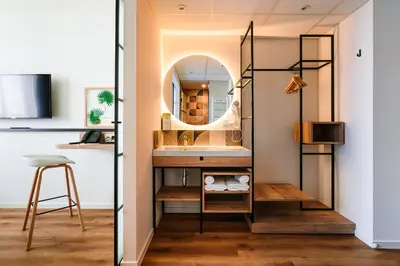 a bathroom with a sink and a mirror at Hotel Convictus Cracovia for business & travellers in Kraków