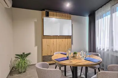 a meeting room with a wooden table and chairs at Hotel Convictus Cracovia for business & travellers in Kraków
