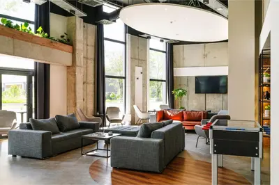 a living room with couches and a tv at Hotel Convictus Cracovia for business & travellers in Kraków
