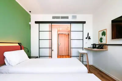 a small bedroom with two beds and a door at Hotel Convictus Cracovia for business & travellers in Kraków