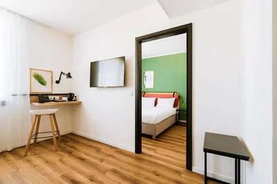 a mirror in a room with a bed and a bedroom at Hotel Convictus Cracovia for business & travellers in Kraków