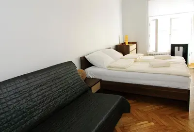 a living room with two beds and a couch at P&J Apartments Floriańska in Kraków
