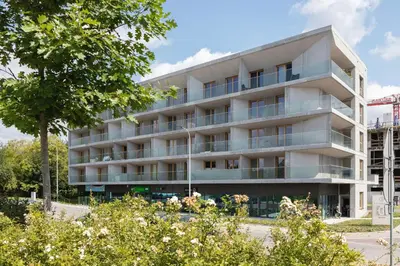 an apartment building with trees in front of it at Solaris Park Apartment Tauron Arena by Renters Prestige in Kraków