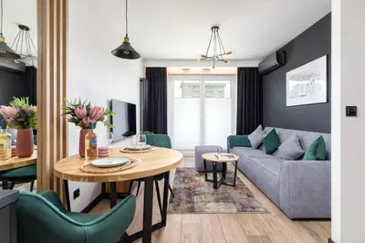 a living room with a couch and a table at Solaris Park Apartment Tauron Arena by Renters Prestige in Kraków