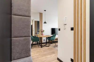 a kitchen and dining room with a table and chairs at Solaris Park Apartment Tauron Arena by Renters Prestige in Kraków