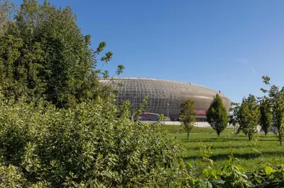 a large building in the middle of a field at Solaris Park Apartment Tauron Arena by Renters Prestige in Kraków