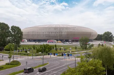 a large building in front of a parking lot at Solaris Park Apartment Tauron Arena by Renters Prestige in Kraków