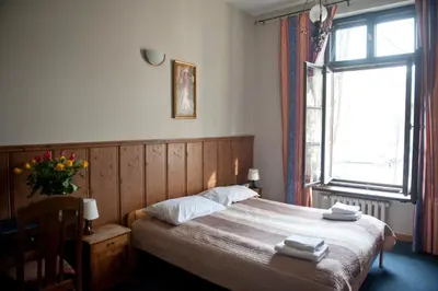 a bedroom with a bed with two towels on it at Dom Casimi in Kraków