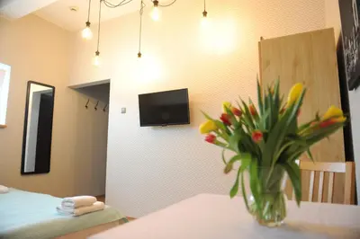 a room with a vase of flowers on a table at Dom Casimi in Kraków