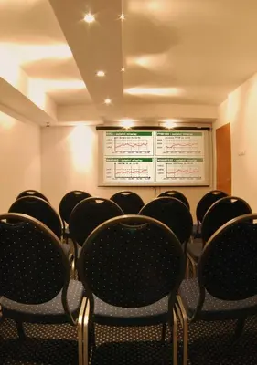 a conference room with black chairs and a projection screen at Dom Casimi in Kraków