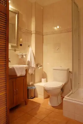 a bathroom with a toilet and a sink and a tub at Dom Casimi in Kraków