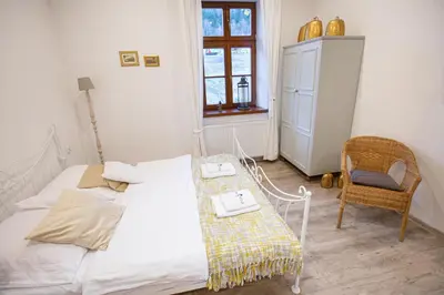 a bedroom with a bed with a table and a chair at Apartamenty Stacja Kasina in Kasina Wielka