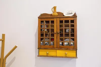 a wooden cabinet with glass doors on a wall at Apartamenty Stacja Kasina in Kasina Wielka