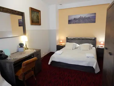 a bedroom with a bed and a dresser and a mirror at Pokoje Gościnne Unikat - Self check in in Kraków