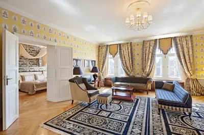 a living room filled with furniture and a chandelier at The Bonerowski Palace Boutique Hotel in Kraków