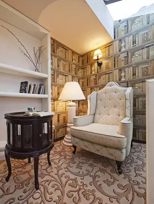 a living room with a chair and a table at The Bonerowski Palace Boutique Hotel in Kraków