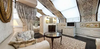 a living room with a couch and a table at The Bonerowski Palace Boutique Hotel in Kraków