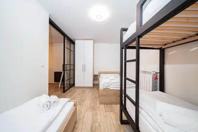 a room with two bunk beds and a hallway at Apartament na Skarpie in Zator