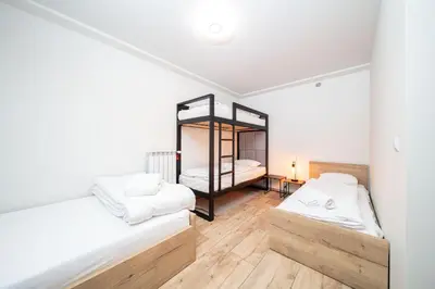 a room with two beds and a mirror at Apartament na Skarpie in Zator