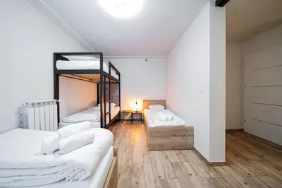a room with two beds and a bunk bed at Apartament na Skarpie in Zator