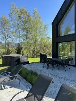 a patio with chairs and a grill in front of a house at STODOŁY94 in Mordarka