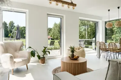 a living room with white furniture and large windows at STODOŁY94 in Mordarka