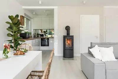 a kitchen and dining room with a fireplace in a living room at STODOŁY94 in Mordarka