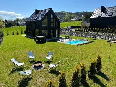 an aerial view of a house with chairs and a fire pit at STODOŁY94 in Mordarka