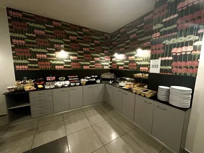 a restaurant with a counter with food on it at Hotel Downtown Kraków in Kraków