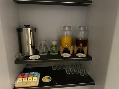 a kitchen with a shelf with glasses and a blender at Hotel Downtown Kraków in Kraków