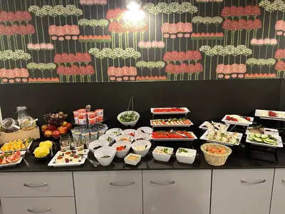 a buffet line with many different types of food at Hotel Downtown Kraków in Kraków