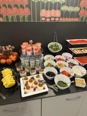 a table topped with lots of different types of food at Hotel Downtown Kraków in Kraków