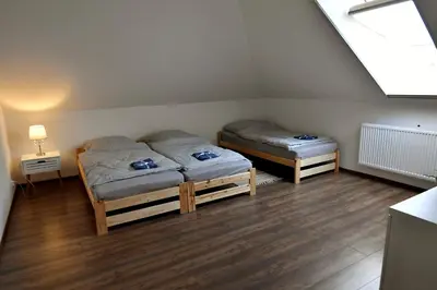 a bedroom with two beds and a window at Apartament u Joli in Miejsce