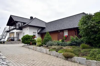 a house with a brick driveway in front of it at Apartament u Joli in Miejsce