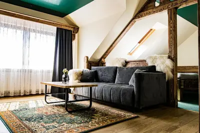 a living room with a couch and a table at Pokoje Gościnne Biały Bizon in Rabka