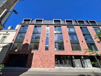 an apartment building with a red brick facade at CozyStudio with Sauna in Kraków