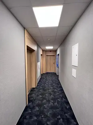 a hallway of an office building with a ceiling at CozyStudio with Sauna in Kraków