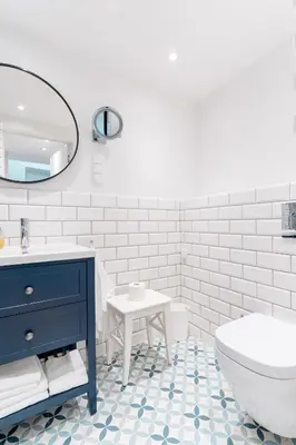 a bathroom with a blue dresser and a sink and a toilet at Kochanowskiego Family Apartments in Kraków