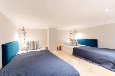 two beds sitting next to each other in a bedroom at Kochanowskiego Family Apartments in Kraków