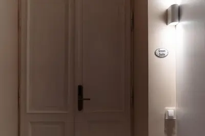 a white door with a clock on it at Kochanowskiego Family Apartments in Kraków