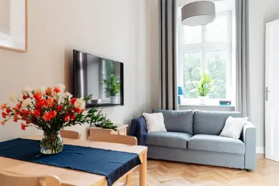 a living room with a couch and a table at Kochanowskiego Family Apartments in Kraków