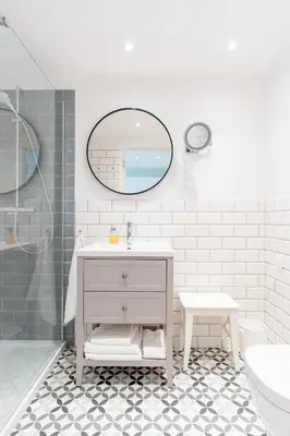a white bathroom with a sink and a mirror at Kochanowskiego Family Apartments in Kraków