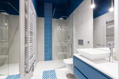 a bathroom with a sink and a toilet at Cadena Gallery Apartments Wyspiański in Kraków