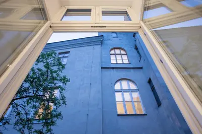 a blue building with windows in front of it at Cadena Gallery Apartments Wyspiański in Kraków