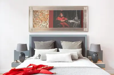 a bedroom with a bed with a red bow on it at Cadena Gallery Apartments Matejko in Kraków