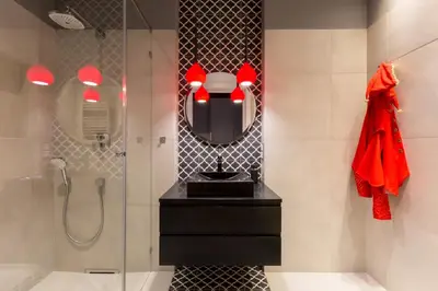 a bathroom with a shower and a mirror at Cadena Gallery Apartments Matejko in Kraków