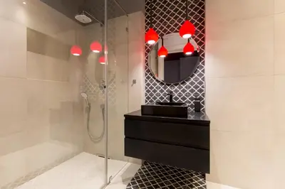 a bathroom with a shower and a sink and a mirror at Cadena Gallery Apartments Matejko in Kraków